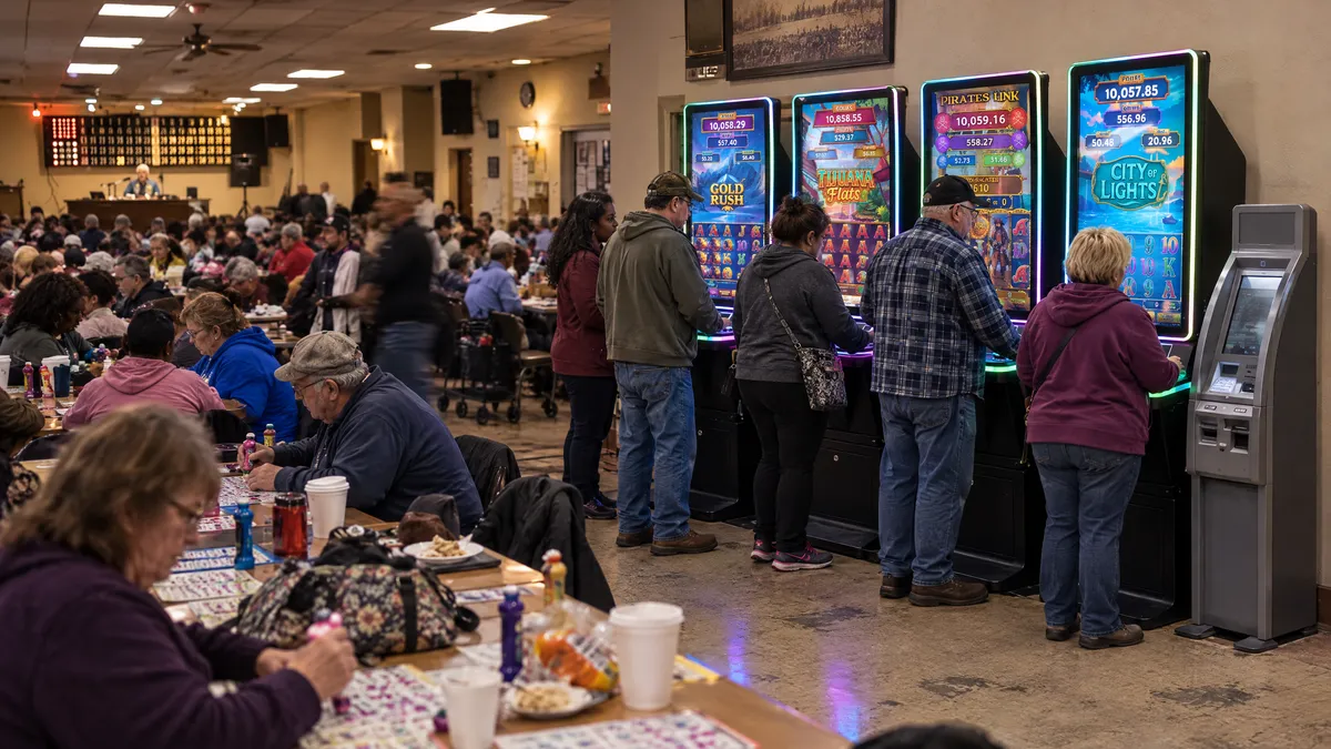 Four Foxfire cabinets and a payout kiosk along the wall of a bingo hall, with players at the machines and a crowd at the bingo tables behind them.